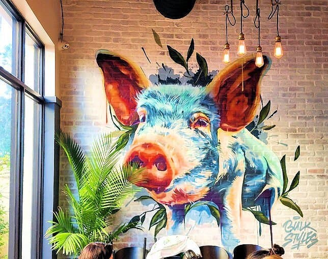 Large colorful pig mural painted by Bulk Styles
